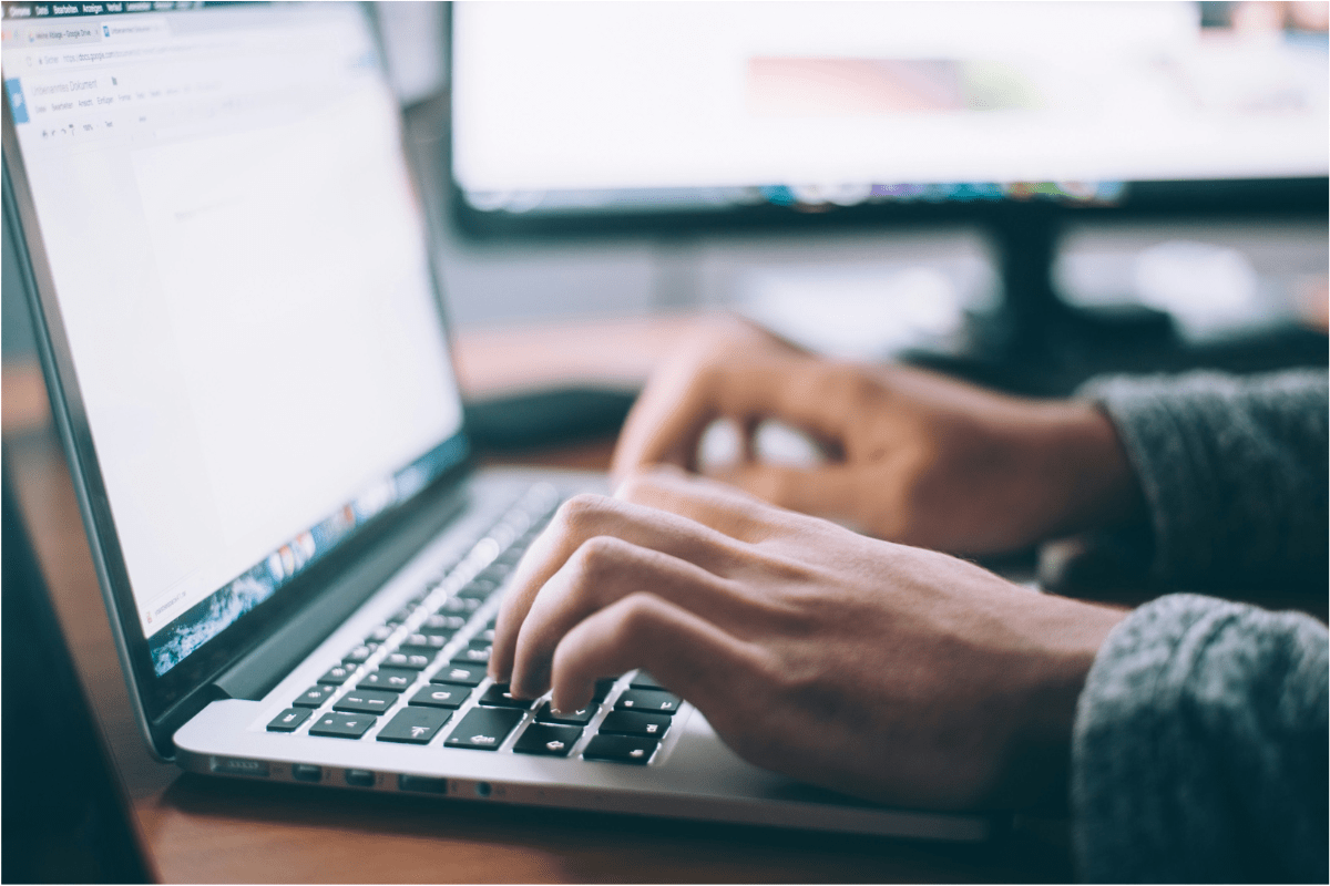 Freelance Medical Writing - Side Gigs for Medical Students - Side Jobs for Medical Students A Person Hands are Visible Typing on Laptop Illustrating Side Gigs for Medical Students - Side Jobs for Medical Students