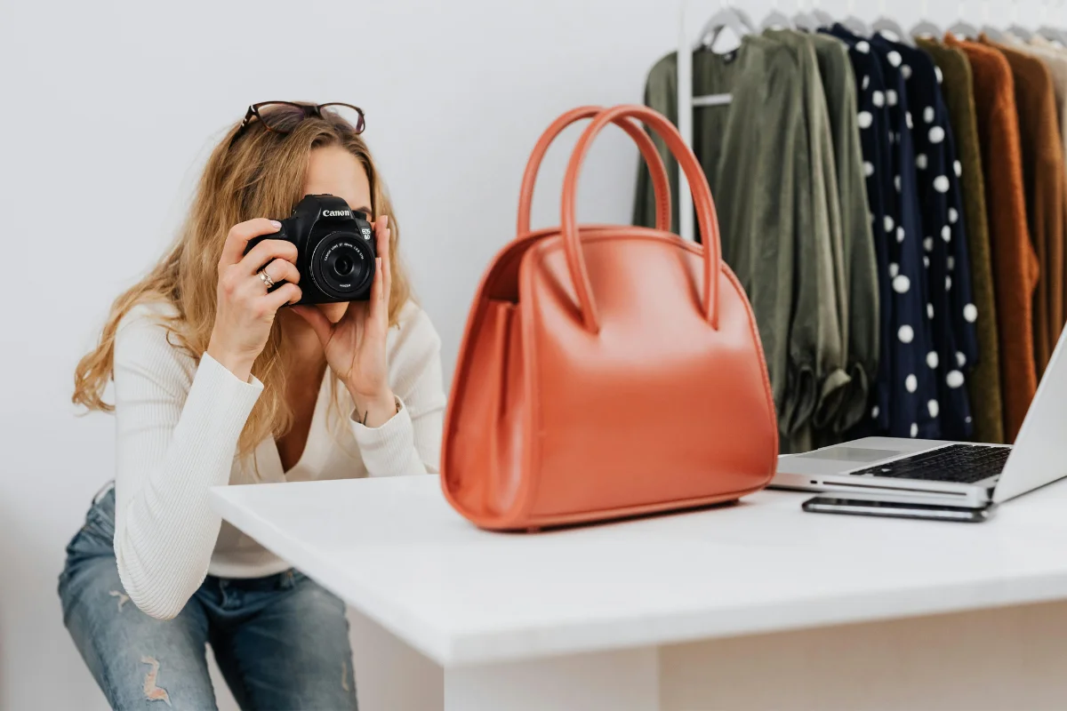 A Woman Photographing a Bag For Her Business. Reselling As a Side Hustles