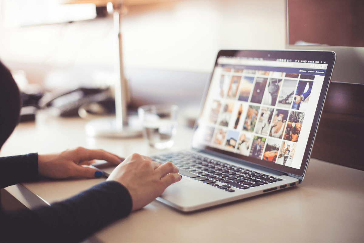 Promote digital Products where you sell Halloween Wallpaper A person using a Laptop with social media app open illustrating how to promote Halloween Wallpapers and Make Money Online.