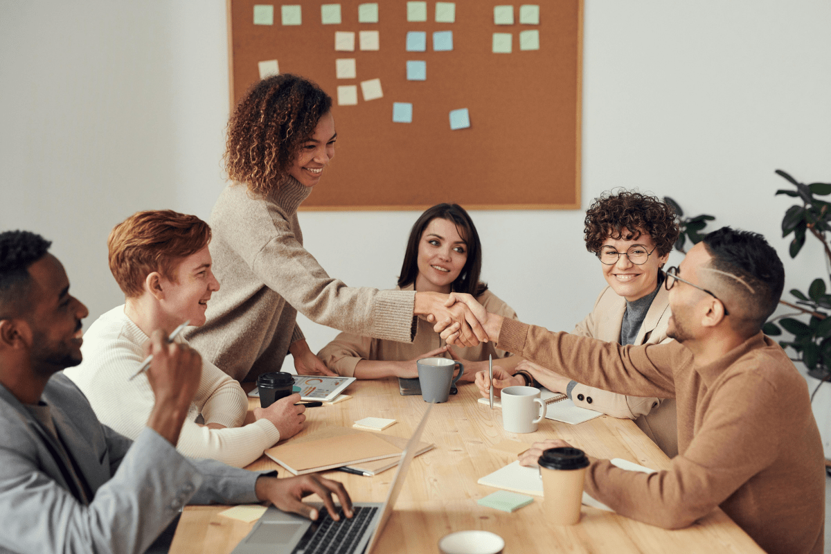 Teamwork - How to Start a Real Estate Business An Image Showing Team Members Sitting Around A Table Discussing Business Demonstrating How to Start a Real Estate Business