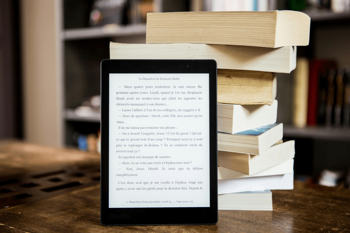 How to Make Money on Amazon Without Selling – Tablet Displaying eBook Next to Stack of Books How to make money on Amazon without selling . A tablet displaying an ebook next to a vertical stack of books