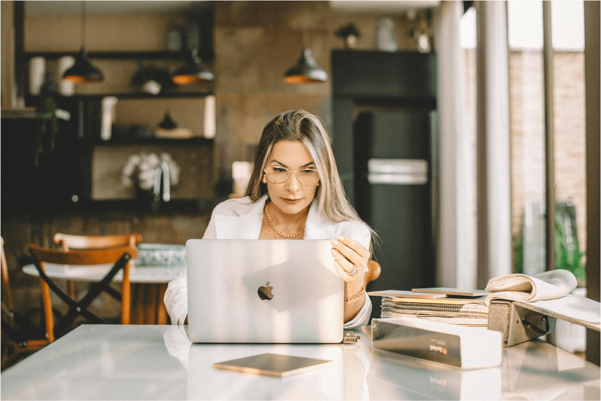 Business Structure - How to Start a Photography Business A Woman Working On Her Laptop Researching About Entity Structure Illustrating How to Start a Photography Business