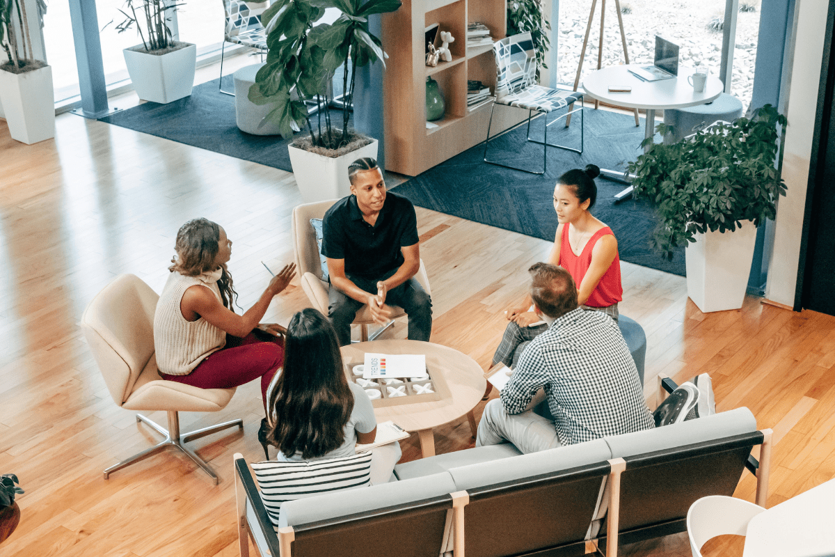 A Group or People Sitting Together Around a Table Illustrating How to Start a Digital Marketing Agency