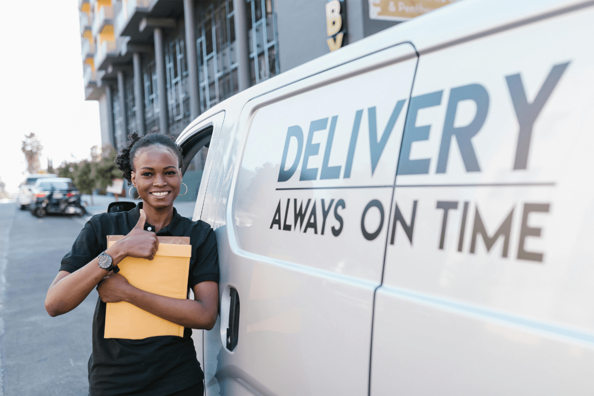 A Woman Standing against a Delivery Wan Illustrating How to dropship from AliExpress to Amazon