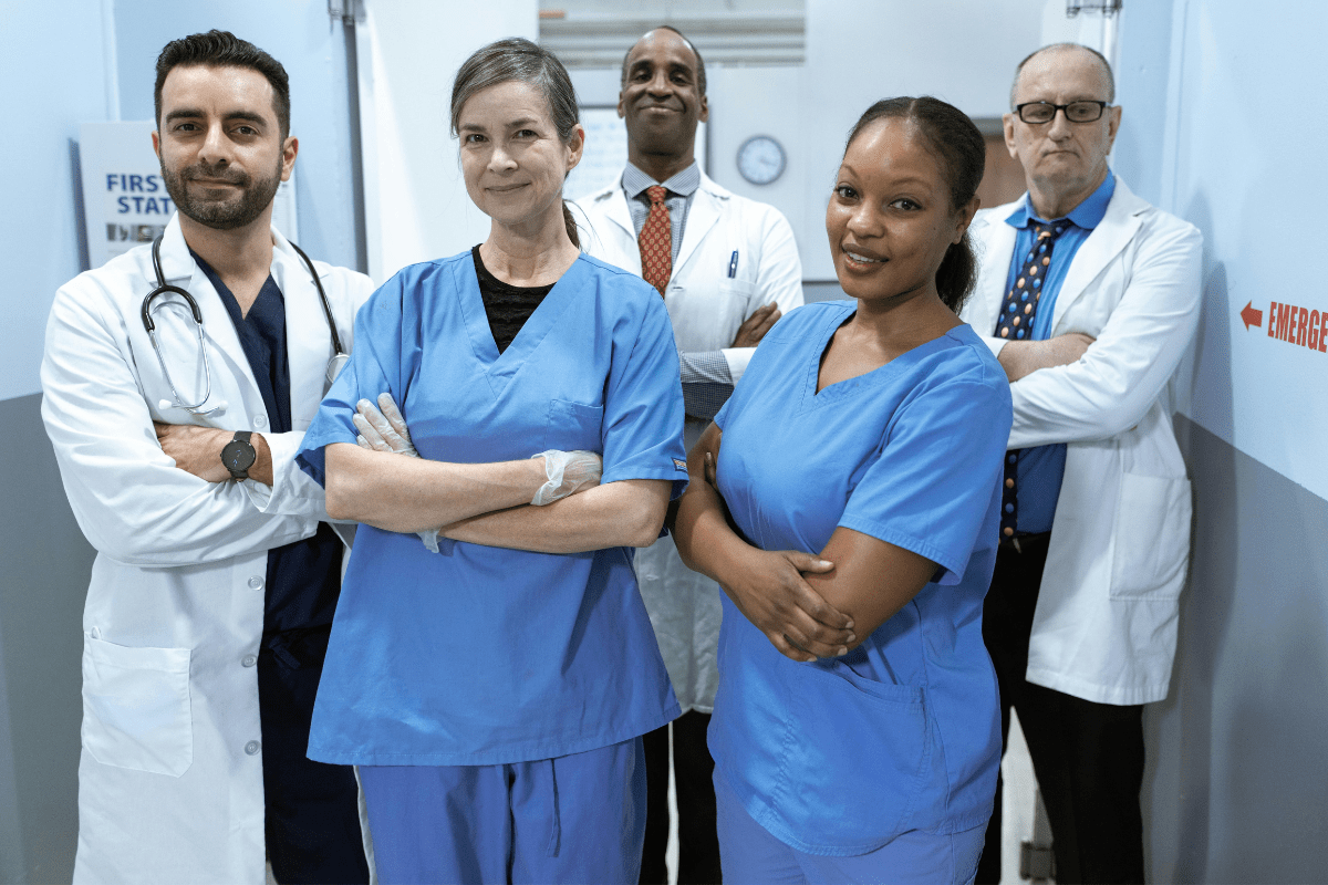 Three Doctors and Two Nurses Standing in a Group Illustrating Best Physician Side Gigs and Side Hustles for Doctors.