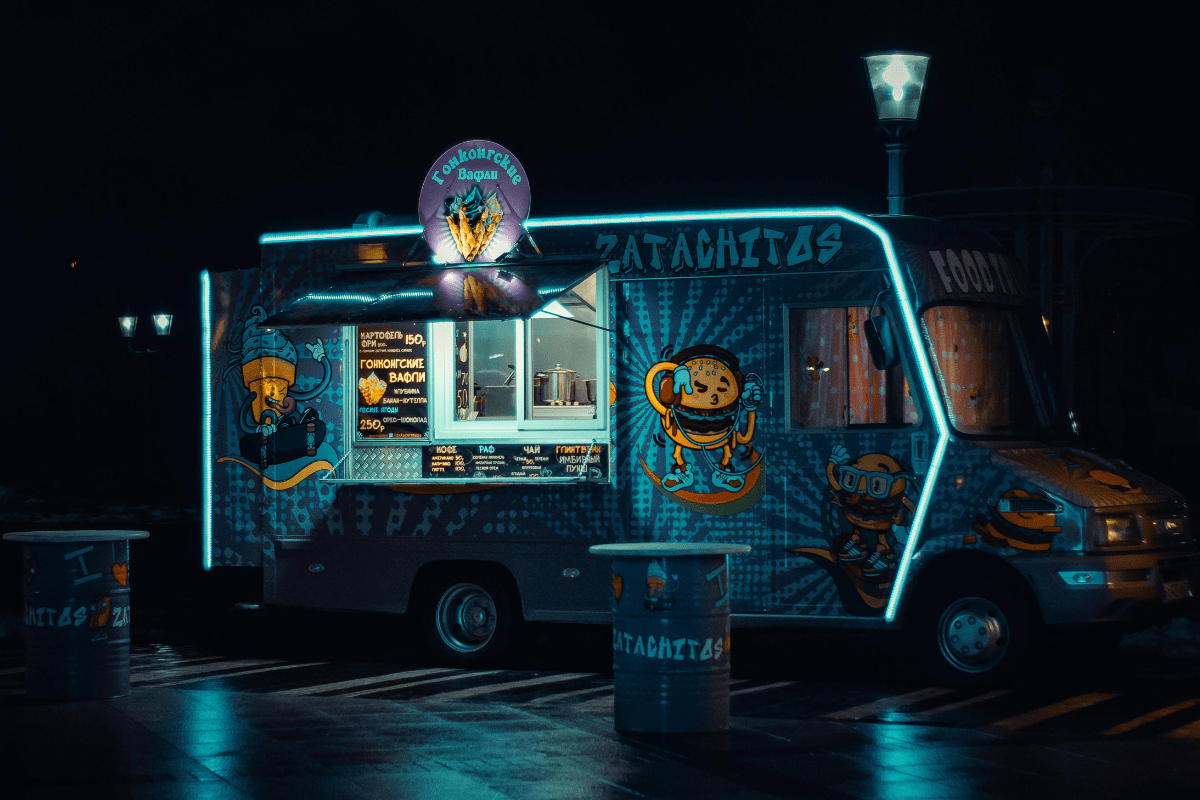 A Fully Customized Food Truck Standing on Road in the Night Time Illustrating How to Start a Food Truck Business