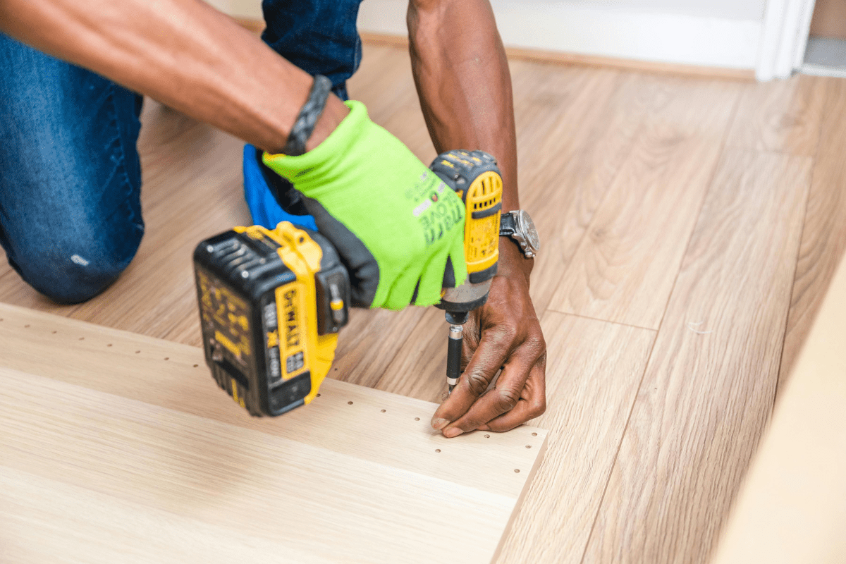 A Man's Hands Cane be Seen Uisng a Machine to Drill Screws Illustrating Handyman Jobs that are Perfect Side Hustles That pay Daily