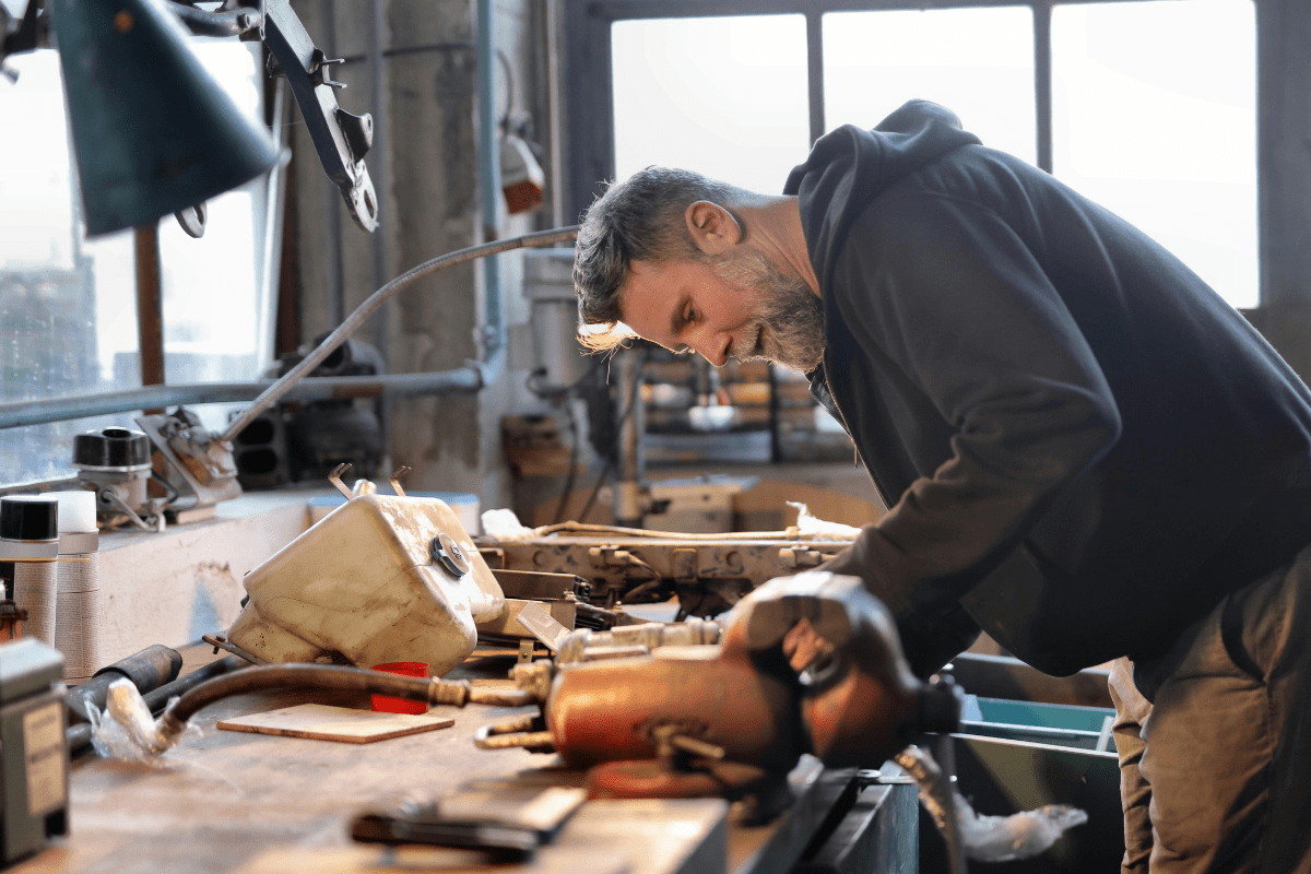 A Handyman Can be Seen Using an Electrical Cutter to Cut Wood Illustrating Doing a Handyman Side Hustle