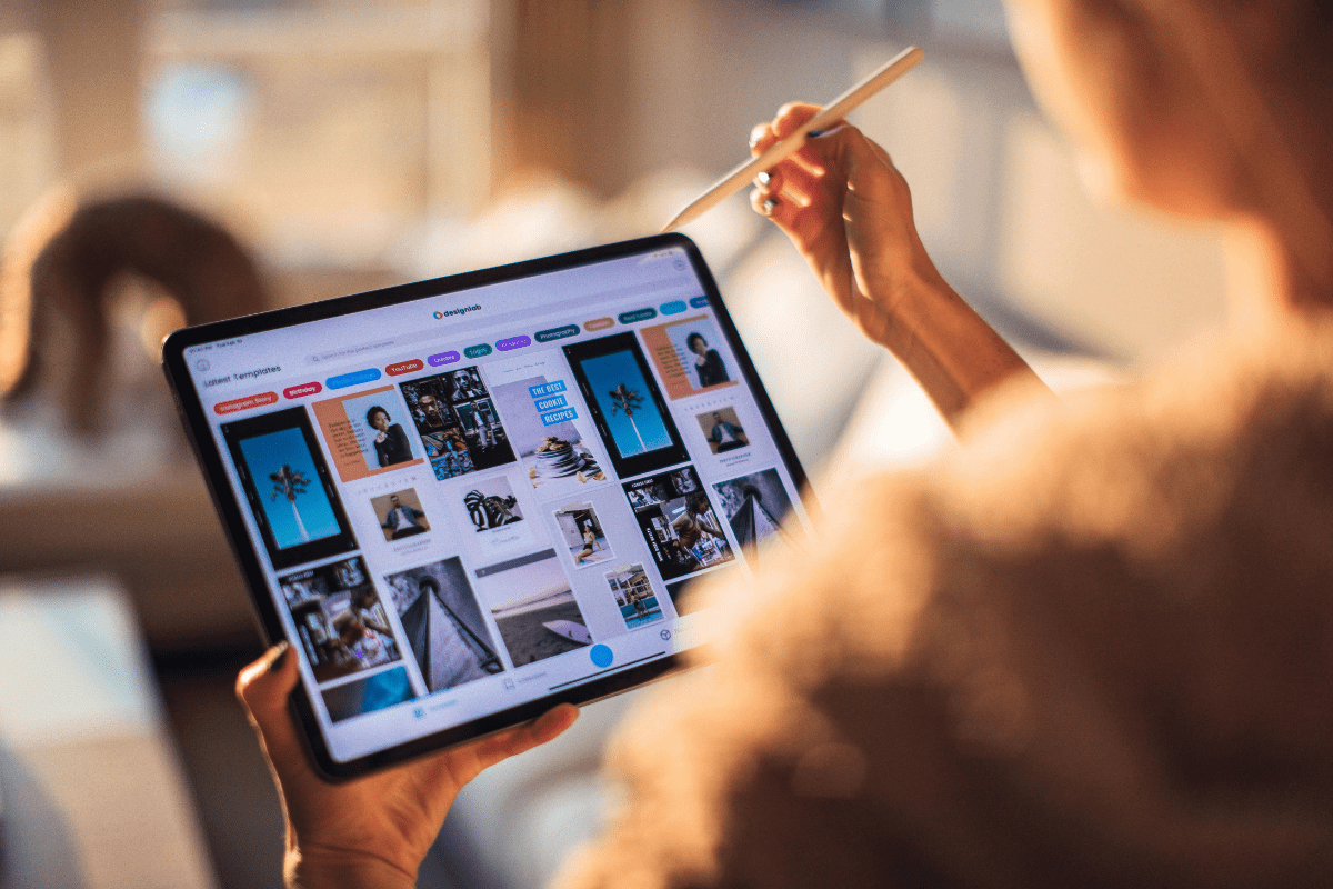 A Person Holding a Tablet Showing Various Printables Illustrating How to Sell Printables on Etsy to Make Money in 2025