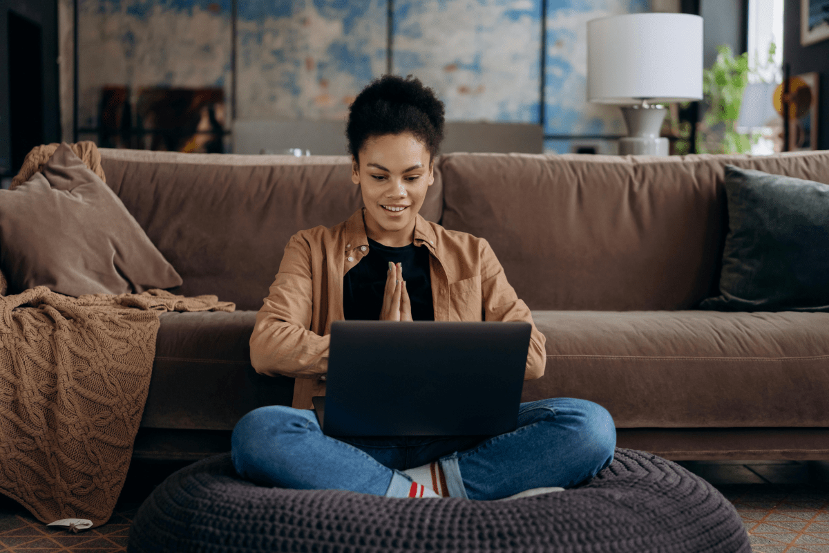 A Woman Working On Her Laptop While Sitting on Couch Illustrating Starting Blogging as a Side Hustle