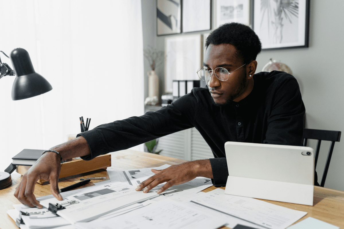 A person Working in his Office, Managing Everything at Once, Illustrating How to Start an Airbnb Without Owning Property.