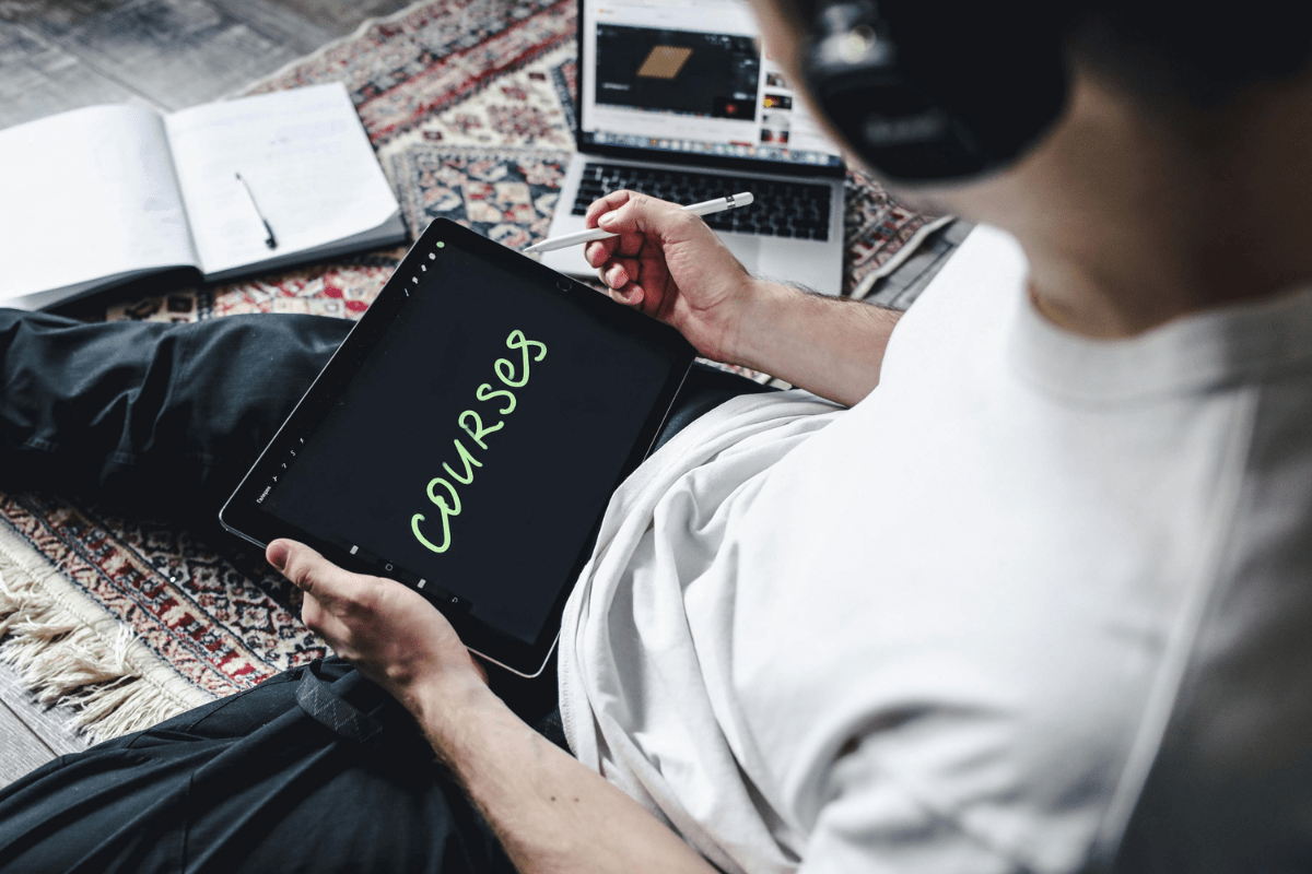 Sell Online Courses - Easy Side Hustles for Teachers A Person Creating an Online Course on Their Tablet Illustrating Easy Side Hustles for Teachers