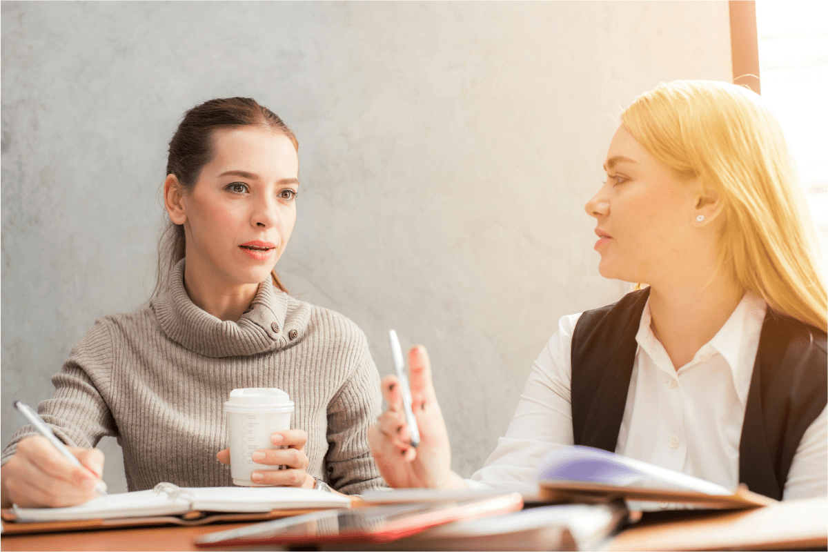 Two Women Sitting Together Discussing best Side Hustles for Single Moms to Make Extra Money