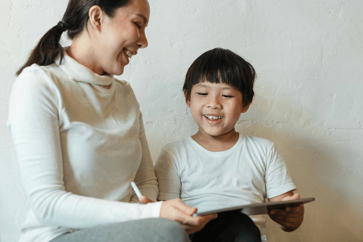 A Women Sitting with a Young Kid Taking Care of Him Illustrating Side Hustles for Single Moms