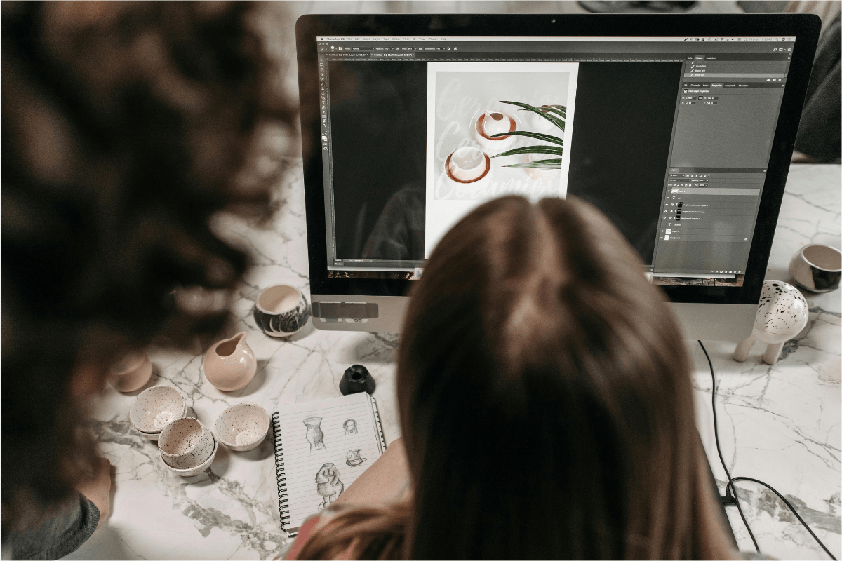 A Woman Working on Her Designs Visible on Her Laptop Screen Illustrating How to Start a Print-On-Demand Business in 2025