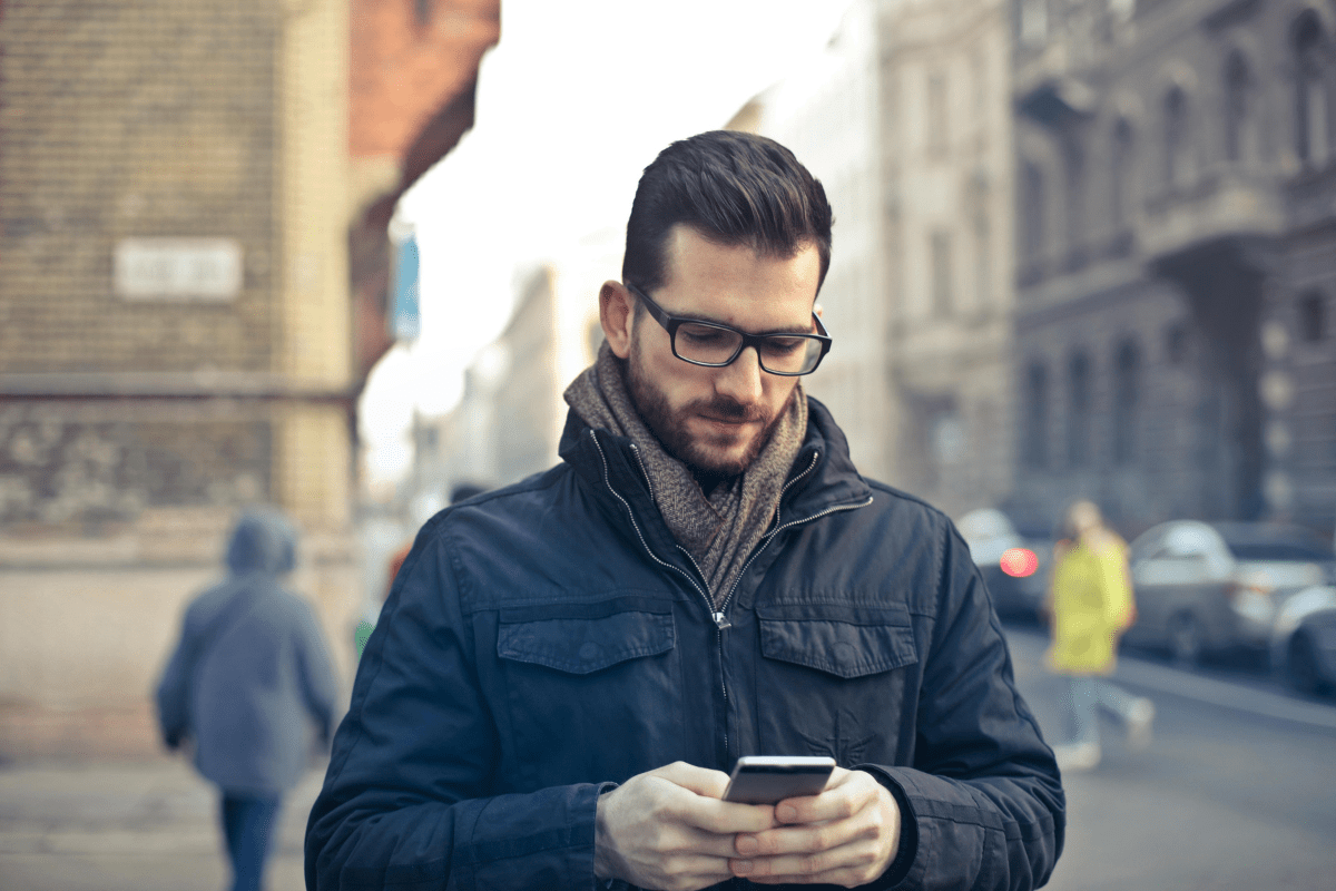 Passive Income - Side Hustle Apps A Person Can be Seen Using Their Phone Taking Surveys Illustrating Side Hustle Apps