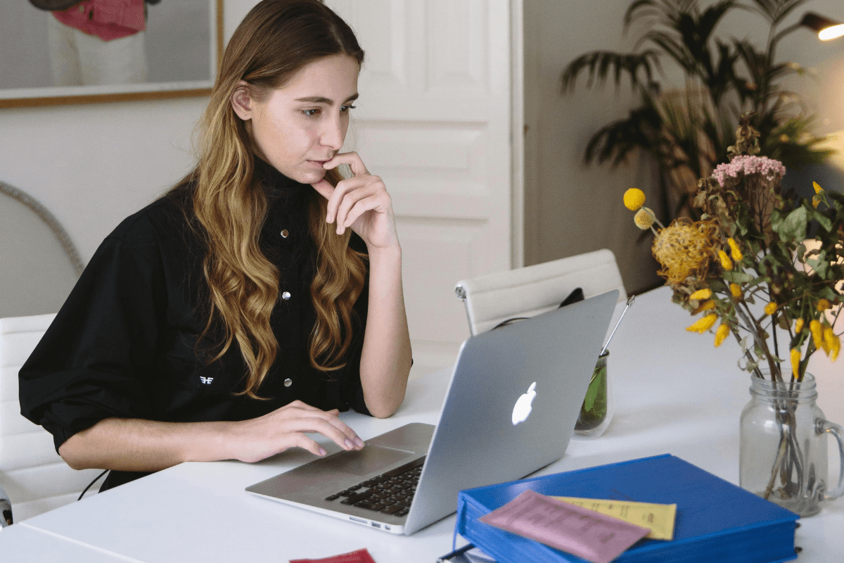 Offer Virtual Assistant Services - Online Side Hustles from Home A Woman Working on Her Laptop Illustrating Online Side Hustles from Home