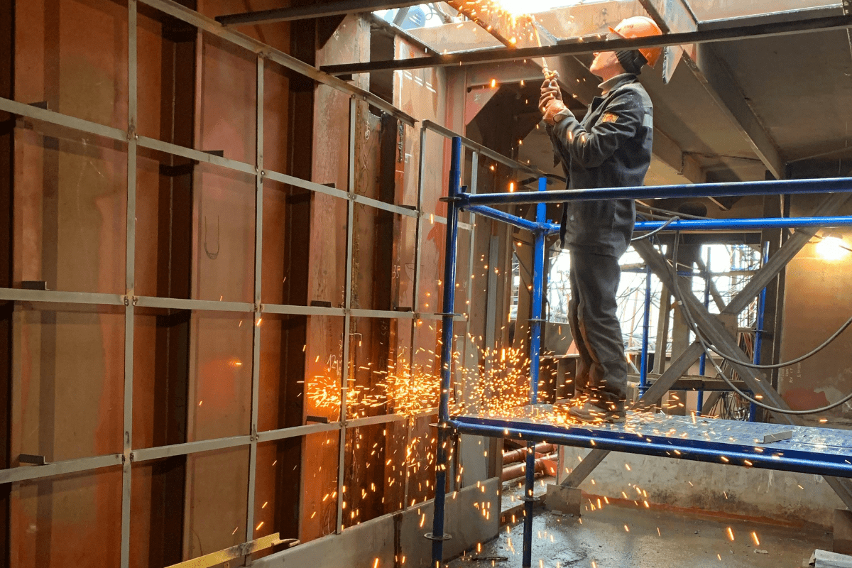 A Person Can Be Seen Welding on a Construction Site Illustrating Welding Side Hustle Ideas