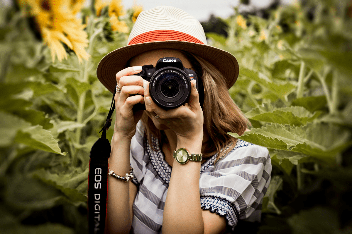 Become a Summer Freelance Photographer - Easy Part Time Summer Jobs That Pay Well A Woman Can Be Seen Taking Photos Illustrating Easy Part Time Summer Jobs That Pay Well