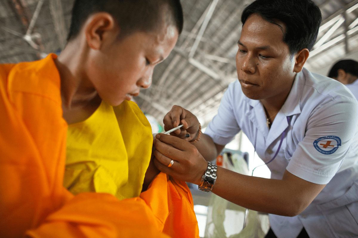 A Male Nurse Administering an Injection Illustrating Business Ideas for Nurses