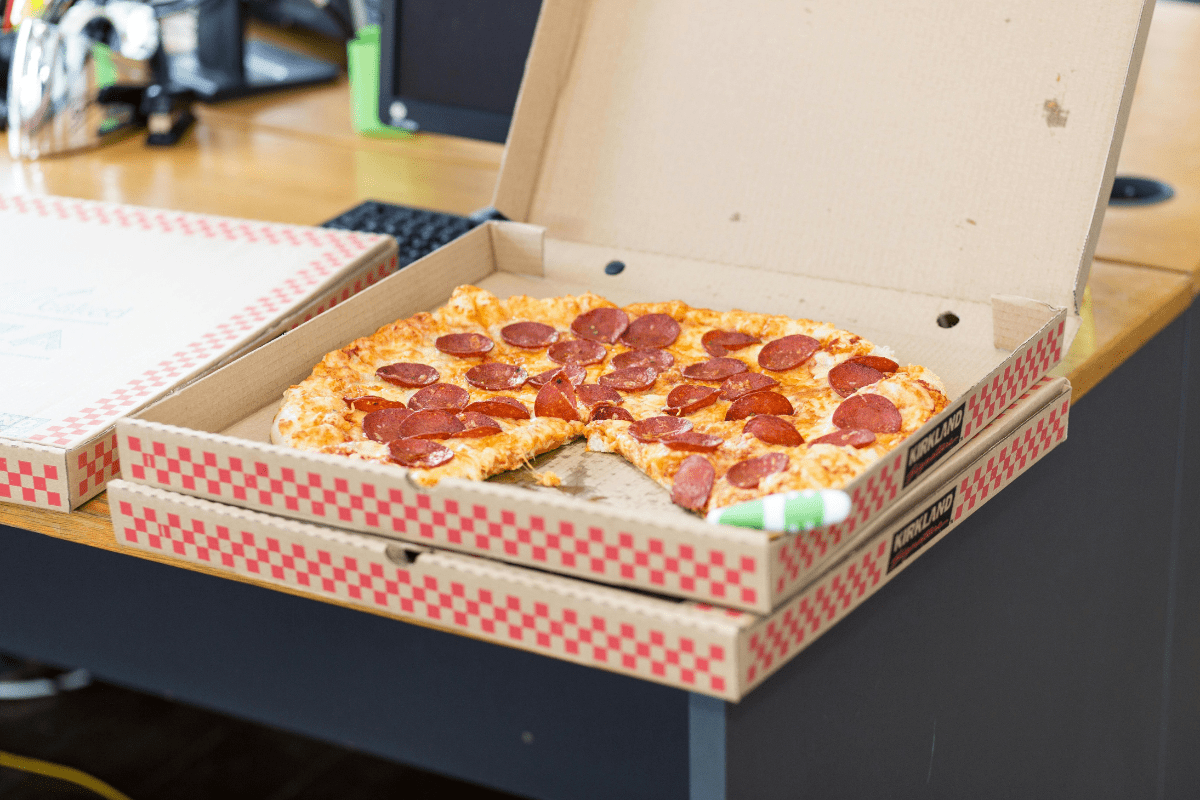 An Open Box With Pizza Inside Stacked Upon another Closed Box Illustrating Pizza Vending Machine Business