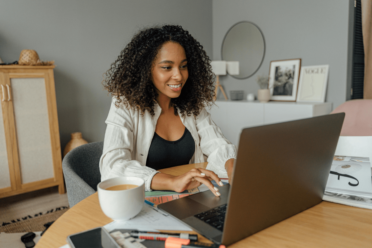 A Woman is Sitting In Front of Her Laptop Illustrating Side Hustles 2025 That Need No Experience