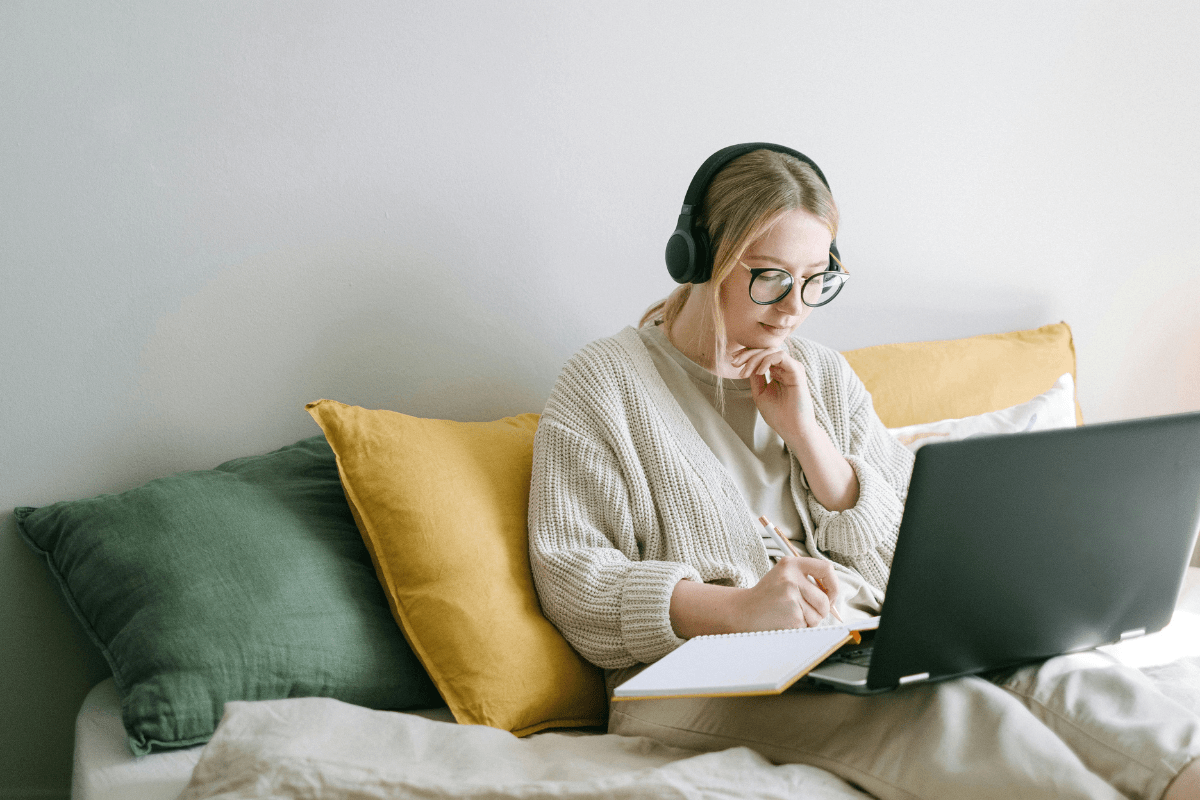 Online Surveys - Side Hustles 2025 That Need No Experience A Woman Sitting on Couch Using Laptop Illustrating Side Hustles 2025 That Need No Experience