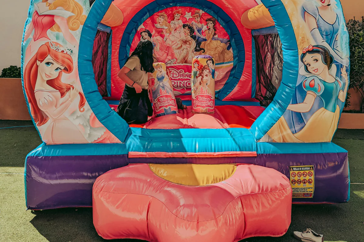 A Girl Can Be Seen Playing in  Princess Themed Castle Illustrating How to Start a Bounce House Business