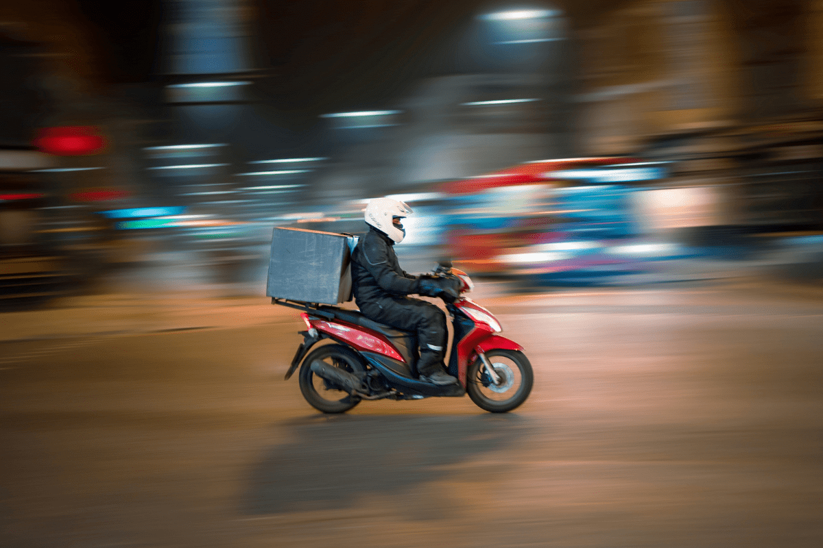 A Delivery Rider Riding on His Bike Illustrating Is DoorDash a Good Side Hustle