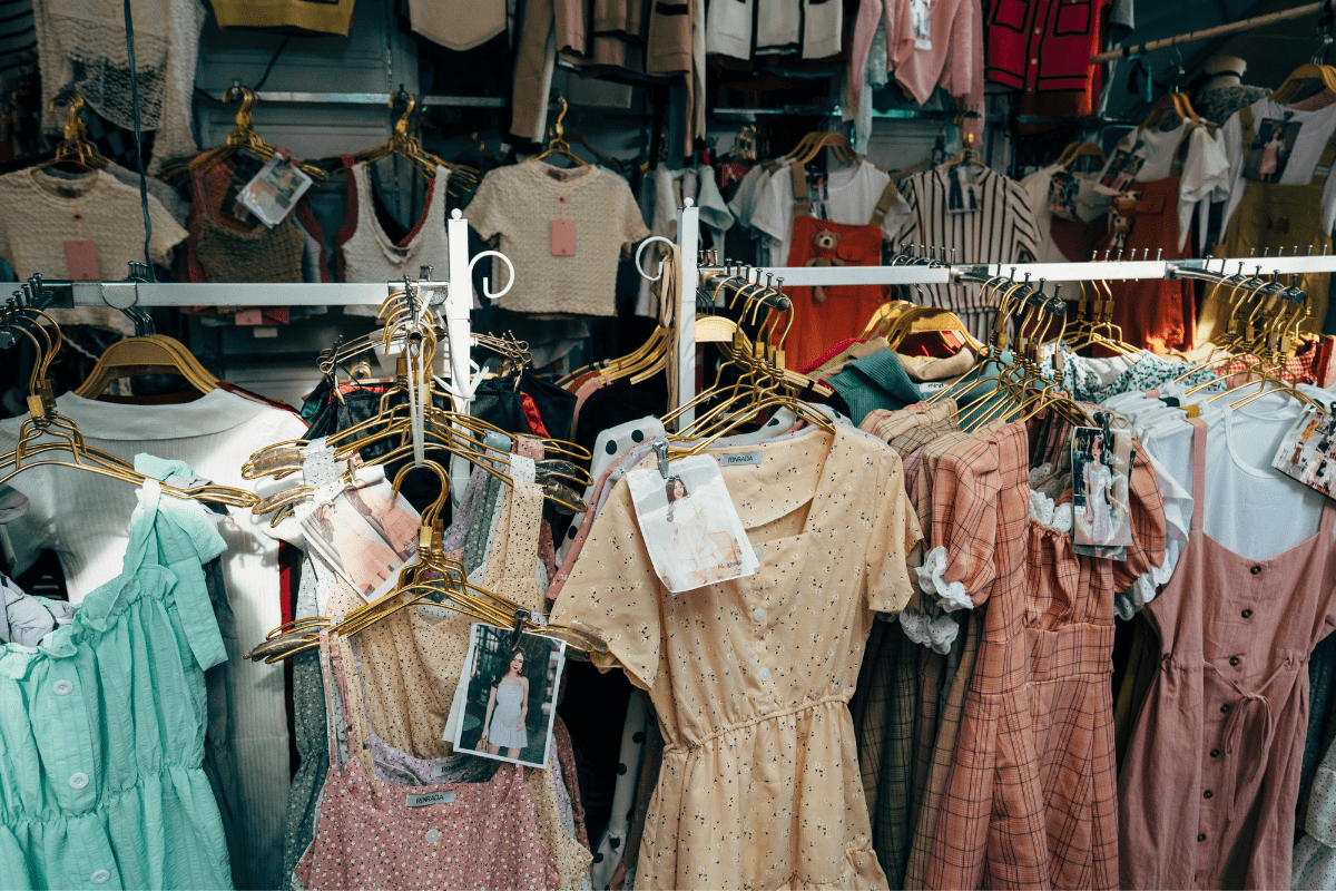 Clothes Can Be Seen in Hanging Stands Illustrating Selling Apparel When Looking for How to Make $100 a Day