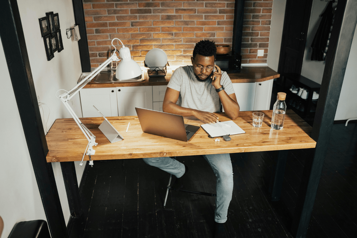 Virtual Assistant - Side Hustles for Introverts A Man Working on Laptop From Home Sitting on Their Table Illustrating Side Hustles for Introverts