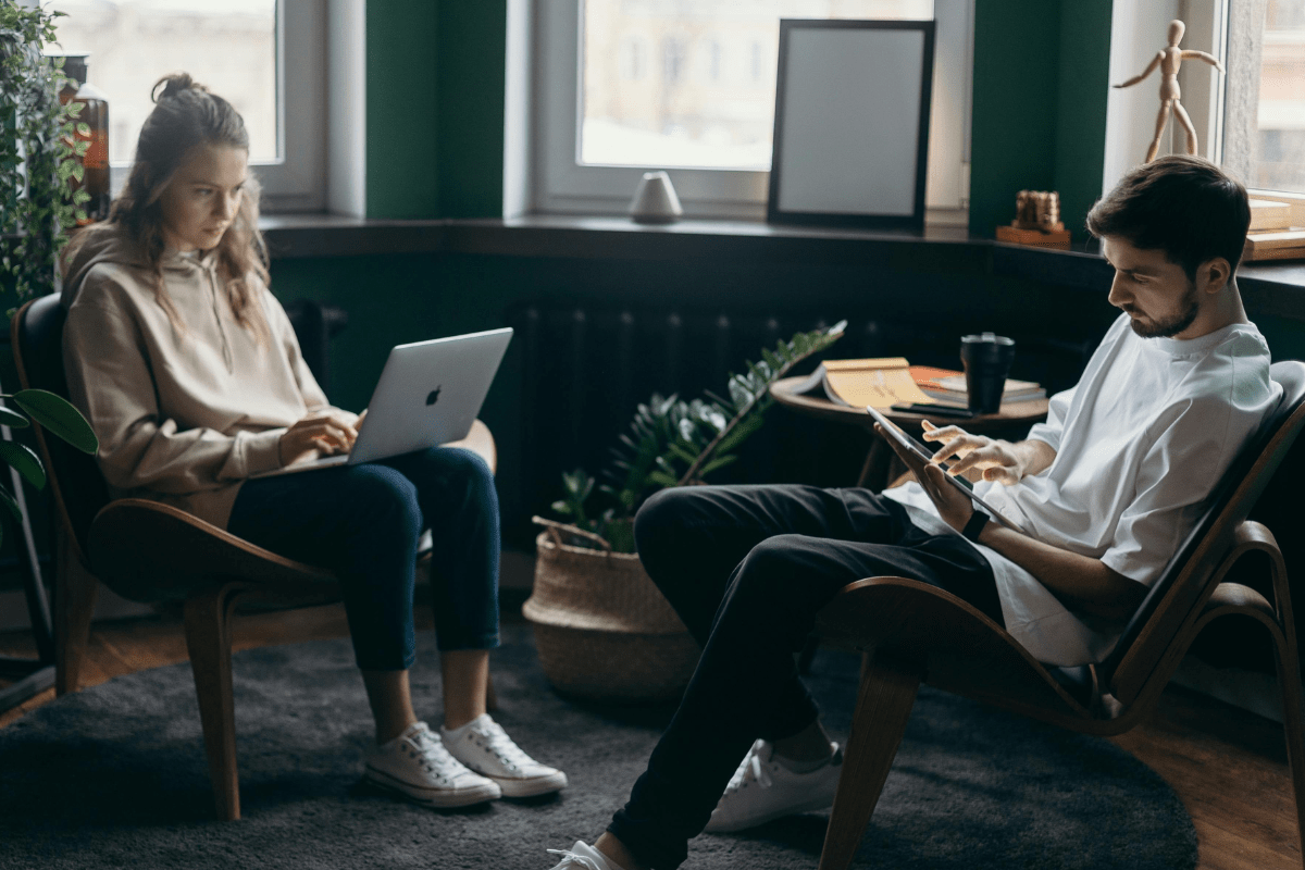 Coding and Web Development - Side Hustles for Introverts Two People Working on Their Laptops Illustrating Coding and Web Development As The Best Side Hustles for Introverts